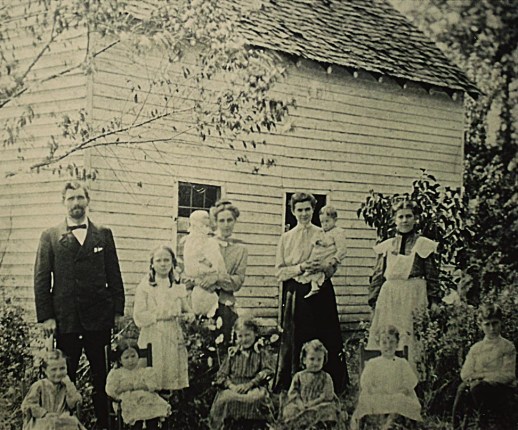 Compton, with the original nine orphans, in front of The Cabin