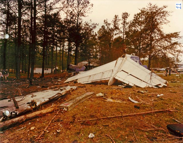 The remnants of the tail section. The separated right wing is in the foreground.