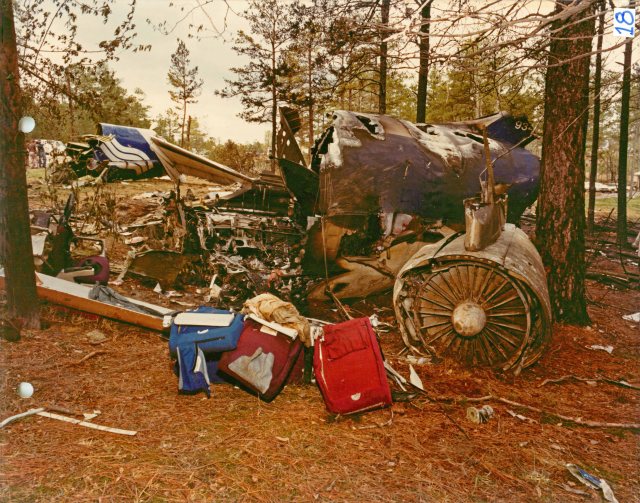Side view of the mid-section of the fuselage and left engine. The tail section is in the background.