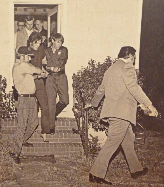 Knowles leaving Dr. Bizzitt's office under armed guard