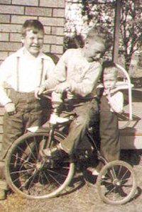 Jimmy (on the bike) keeping a close eye on his brother Earl